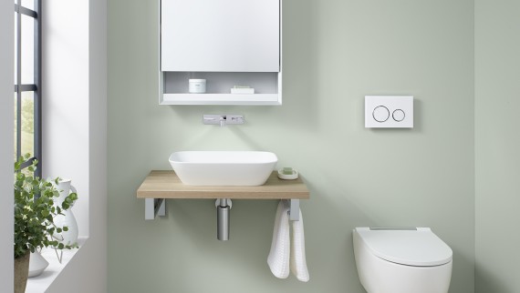 Guest bathroom in mint green with wall-hung toilet and Geberit in-wall toilet system