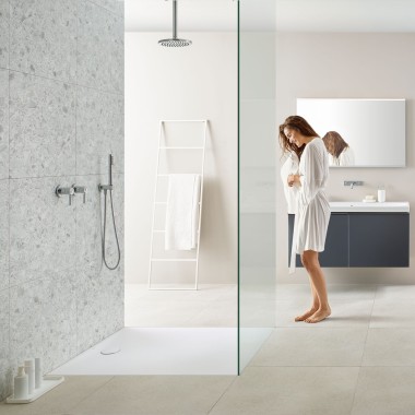 Woman in bathroom with walk-in shower