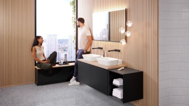 Woman sitting on windowsill in bathroom