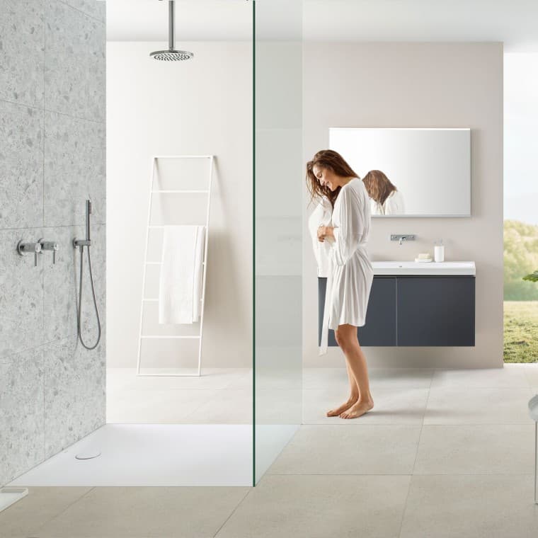Woman in bathroom with walk-in shower Woman in bathroom with walk-in shower